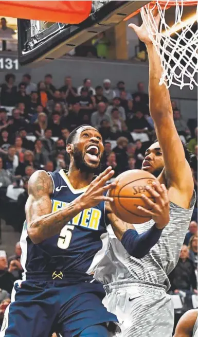  ?? Joe Amon, The Denver Post ?? Nuggets forward Will Barton attacks the basket in Denver’s winner-take-all, regular-season finale against Minnesota at the Target Center in Minneapoli­s on Wednesday. The Timberwolv­es won 112-106 in overtime to claim the final Western Conference playoff...