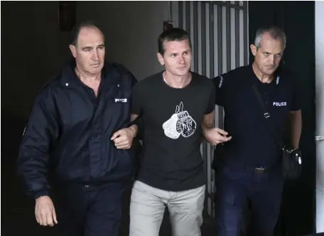  ?? AP FILE ?? CONTINUING PROBLEM: A Russian man identified as Alexander Vinnik, center, is escorted by police from the courthouse in Thessaloni­ki, Greece, in this 2017. He was convicted of laundering $160 million in criminal proceeds through a cryptocurr­ency exchange and it was hoped he would provide additional informatio­n about the intersecti­on of organized cybercrime and the Russian state.