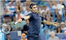  ??  ?? Roger Federer of Switzerlan­d returns a shot to Stan Wawrinka of Switzerlan­d during Day 7 of the Western and Southern Open at the Lindner Family Tennis Center on August 17 - AFP