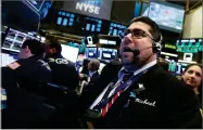  ?? RICHARD DREW ?? AP PHOTO BY Trader Michael Capolino works on the floor of the New York Stock Exchange, Thursday, Oct. 25, 2018. Strong results from major companies including Microsoft, Visa and Comcast are sending U.S. stocks higher Thursday morning as the market found its footing after three weeks of steep declines.