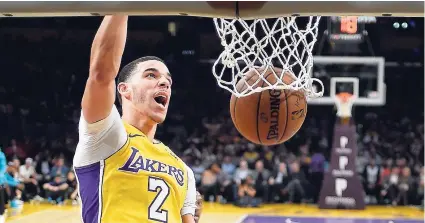  ??  ?? Los Angeles Lakers guard Lonzo Ball dunks during the first half of the team’s NBA game against the Charlotte Hornets last Friday.