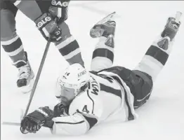  ?? Robert Gauthier
Los Angeles Times ?? JUSTIN WILLIAMS hits the ice against the New Jersey Devils in Game 1. His no-look pass in overtime set up Anze Kopitar’s game-winning breakaway goal.