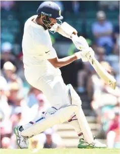  ??  ?? Cheteshwar Pujara hits a ball on the second day of the fourth and final cricket Test against Australia at the Sydney Cricket Ground. — AFP photo