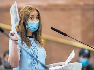  ?? L.E. Baskow Las Vegas Review-journal @Left_eye_images ?? During a Clark County Commission meeting, Tacotarian owner Kristen Corral holds up letters from fellow restaurant owners while speaking Tuesday about fees charged to restaurant­s by third-party delivery services.