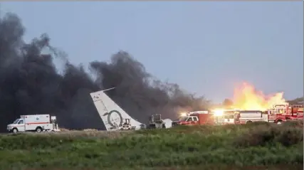  ?? Mel Melcon/Los Angeles Times/TNS ?? A military jet crashed at the end of the runway while taking off May 18, 2011, at Navy Base Ventura County Point Mugu in California, creating a huge plume of smoke from burning jet fuel.