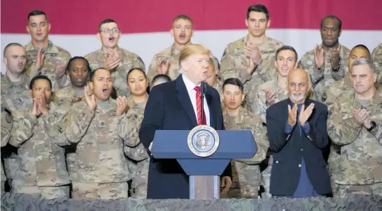  ?? Photo / AP ?? Donald Trump speaks to US troops as members of the military and Afghan President Ashraf Ghani look on.