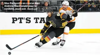  ?? PHOTO AFP ?? Max Pacioretty en course avec Andrew MacDonald pour la rondelle, jeudi soir.