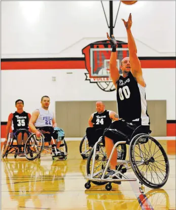  ?? RACHEL ASTON ?? The Las Vegas Yuccas’ Nate Carruth (00) shoots at a wheelchair basketball tournament against the Magee Spokesmen on Sunday at the Paul McDermott Physical Education Complex at UNLV. Carruth, born without a femur, had his foot amputated. He discovered...