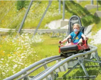  ?? PHoTo couRTeSy Vail ReSoRTS ?? DOWNHILL RUN: A masked visitor takes a ride on the Timber Ripper Mountain Coaster at Okemo in Vermont.