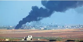  ?? LEFTERIS PITARAKIS/AP ?? Smoke billows in Syria during bombardmen­t by Turkish forces Wednesday in a photo taken from the Turkish side of the border.