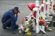  ?? JOHN LOCHER - THE ASSOCIATED PRESS ?? A man cries beside a cross at a makeshift memorial near the scene of a mass shooting at a shopping complex Tuesday, in El Paso, Texas.