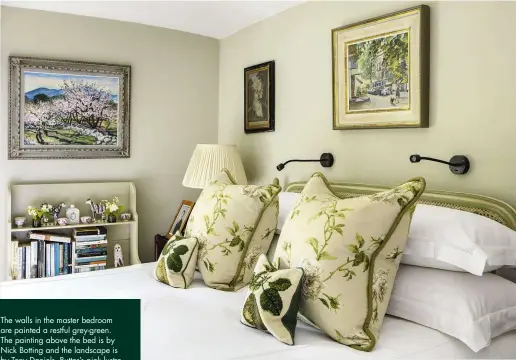 ??  ?? The walls in the master bedroom are painted a restful grey-green. The painting above the bed is by Nick Botting and the landscape is by Tony Daniels. Butter’s pink lustre teacups are dotted along the top shelf of the bookcase. A wonderful chest of...