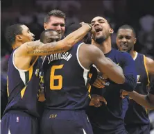  ?? Mark J. Terrill / Associated Press ?? Utah’s Joe Johnson celebrates with teammates after hitting the game-winner at the buzzer in Game 1 against the Clippers.