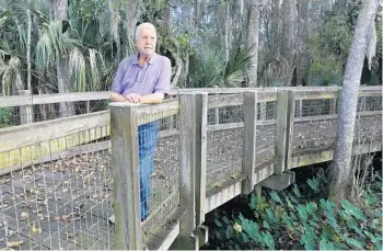  ?? SKENE/ORLANDO SENTINEL 2015 GEORGE ?? Jim Thomas stands on the long boardwalk built at Oakland Nature Preserve to get through wetlands to Lake Apopka.