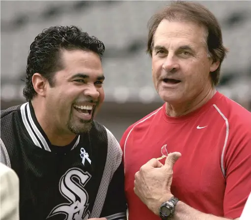  ?? BRIAN KERSEY/AP ?? Ozzie Guillen and Tony La Russa joke around before a game between the White Sox and Cardinals when both were managing in 2006.