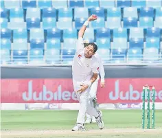  ??  ?? Pakistani cricketer Mohammad Abbas bowls during the fifth day of play of the first Test cricket match in the series between Australia and Pakistan at the Dubai Internatio­nal Stadium in Dubai. — AFP photo