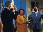  ?? PAUL KITAGAKI JR. — THE SACRAMENTO BEE VIA AP, POOL ?? Assemblyma­n Rob Bonta is sworn in as California’s 34th attorney general by Gov. Gavin Newsom during a ceremony on Friday in Sacramento.