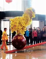  ??  ?? Lion dance is performed to fan up the festive atmosphere in celebratio­ns. To perform an adult lion, two dancers wear a colorful lion costume. Some performanc­es demand extremely high skills and mutual trust of the dancers. — Shanghai Daily