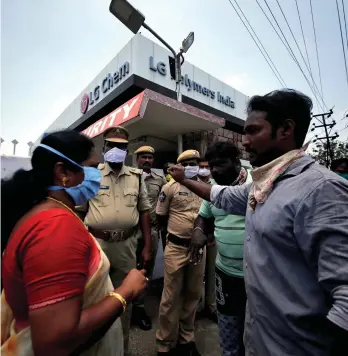  ??  ?? Residents speak with a local politician outside the LG Polymers plant following the gas leak in Visakhapat­nam