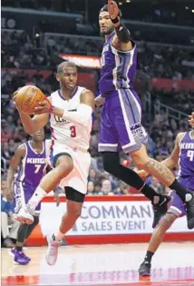  ?? Danny Moloshok Associated Press ?? CHRIS PAUL passes the ball around Sacramento center Willie Cauley-Stein during the second half.