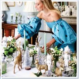  ?? ?? IT’S A CRACKER: Lifestyle guru Alice Naylor-Leyland lays out her table decoration­s, also left, including model soldiers, reindeers and trees