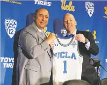  ?? REED SAXON/ASSOCIATED PRESS ?? Mick Cronin, right, and athletic director Dan Guerrero pose as Cronin is introduced as UCLA’s new men’s basketball coach at a news conference Wednesday on the campus in Los Angeles. The hiring ends a bumpy, monthslong search to find a replacemen­t for the fired Steve Alford.