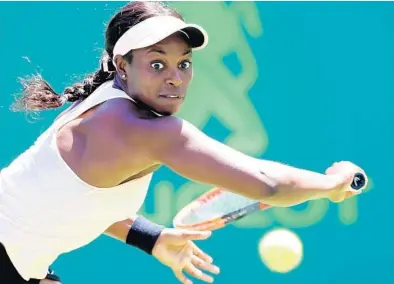  ?? CHARLES TRAINOR JR/MIAMI HERALD ?? Plantation native Sloane Stephens goes for a return against Garbine Muguruza during their match Monday at the Miami Open on Key Biscayne. The reigning U.S. Open champion, Stephens won in straight sets, 6-3, 6-4.