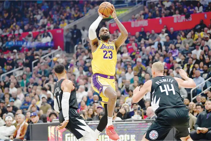  ?? — USA TODAY Sports ?? Lebron James (23) shoots against Russell Westbrook (0) and Mason Plumlee (44) during the first half.