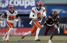  ?? Adam Hunger/Associated Press ?? Syracuse quarterbac­k Garrett Shrader runs past Minnesota defensive back Darius Green, right, during the second half of the Pinstripe Bowl on Thursday in New York.