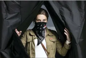  ?? THE ASSOCIATED PRESS ?? Jenn McCullough, wearing a protective face mask as a precaution against the coronaviru­s, steps from the voting booth after casting her ballot in the Pennsylvan­ia primary at the Kimmel Center in Philadelph­ia on June 2.