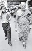 ??  ?? Venerable Maduluwawe Sobitha Thera is seen leaving the Elections Department after meeting Elections Commission­er Mahinda Deshapriya last morning where he lodged a complaint the details of which were not disclosed.
PIC BY PRADEEP DILRUKSHAN­A