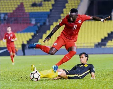  ?? — Bernama ?? Mistimed challenge: Malaysia’s Baddrol Bakthiar sliding in with a tackle during the Asian Cup qualifiers Group B first leg against Hong Kong on Sept 6. The match ended 1-1.