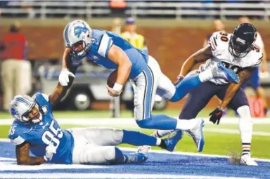  ??  ?? Detroit Lions quarterbac­k Matthew Stafford scrambles for a touchdown Sunday against the Chicago Bears. Stafford threw for 223 yards and two touchdowns. Rey Del Rio, Getty Images