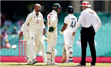  ?? GETTY IMAGES ?? Tim Paine and Nathan Lyon question umpire Paul Wilson over a DRS referral against Cheteshwar Pujara yesterday at Sydney Cricket Ground.