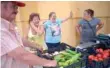  ?? — AFP ?? Residents sell vegetables in “Los Pajaritos” housing project in Sevilla, Spain.