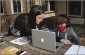  ?? LEAH WILLINGHAM — THE ASSOCIATED PRESS ?? Angela Atkins helps her son Jess Atkins work on a math problem on his laptop during home schooling at their home in Oxford, Miss., on Dec. 18. Angela Atkins has been homeschool­ing Jess and his brother, Billy, since October.