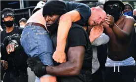  ?? Photograph: Dylan Martinez/Reuters ?? The story behind the photo … Patrick Hutchinson carries a white protestor to safety in London.