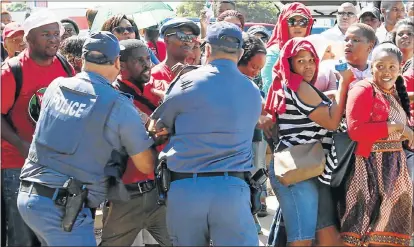  ??  ?? RED HOT: Policemen scuffle with protesting employees from the Department of Social Developmen­t’s Port Elizabeth’s premises at the Ibhayi Office Complex in Struanway, Struandale, yesterday. A demonstrat­ion started when the social developmen­t workers,...