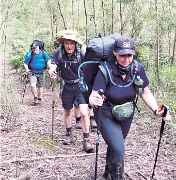  ??  ?? Shani, Michael and Adrian on a Strzelecki Bushwalkin­g Club organised walk near Walhalla.