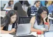  ??  ?? Bryanna Gilges, left, and Yvonne Gonzalez work on an exercise during a Girls Who Code class in 2014. FILE PHOTO BY ERIC RISBERG, AP