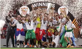  ?? Photograph: Gonzalo Arroyo/UEFA/Getty Images ?? Sevilla’s Ivan Rakitic lifts the trophy after the victory on penalties over Roma.