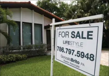  ?? LYNNE SLADKY — THE ASSOCIATED PRESS ?? In this Aug. 15 photo, a for sale sign is placed in front of a home in Miami. A key housing index shows that U.S. home prices rose solidly in June, another sign of renewed health in the housing market. The Standard & Poor’s/Case-Shiller 20-city home...