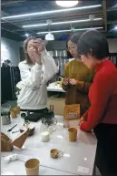  ?? PROVIDED TO CHINA DAILY ?? Young women learn how to make coffee during a lesson at a Beijing night school.