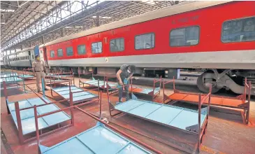  ?? REUTERS ?? A worker paints beds to be used at a ‘railway hospital’ to accommodat­e people suffering from Covid-19 in Chennai, India.