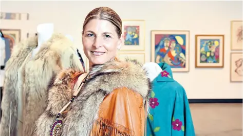  ?? CHERYL CLOCK/ STANDARD STAFF ?? Michele-Elise Burnett, in the art gallery at the Marilyn I. Walker School of Fine and Performing Arts in St. Catharines, is surround by her late mother's collection of Indigenous artwork and some of her clothing. Her mother, Suzanne Rochon-Burnett, a...
