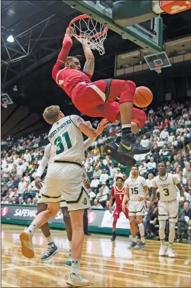  ?? Associated Press ?? Slammed: Arkansas' Daniel Gafford (10), a former standout at El Dorado, dunks over Colorado State's Adam Thistlewoo­d (31) during their game Wednesday in Fort Collins, Colo. Arkansas hosts Western Kentucky today.