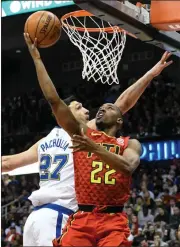  ?? John Amis / AP ?? Atlanta Hawks guard Isaiah Taylor (22) shoots as Golden State Warriors center Zaza Pachulia defends during the first half of Friday’s game in Atlanta.