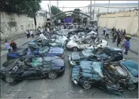  ?? ROMEO RANOCO / REUTERS ?? A bulldozer destroys smuggled luxury cars worth $1.2 million, which include used Lexus, BMW, Mercedes-Benz, Audi, Jaguar and Corvette Stingrays, during the 116th Bureau of Customs founding anniversar­y in Manila, the Philippine­s, on Tuesday.