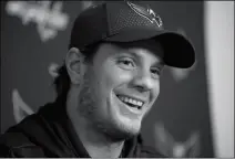  ?? ASSOCIATED PRESS ?? WASHINGTON CAPITALS’ John Carlson smiles during a media availabili­ty at their practice facility Monday in Arlington, Va. The Washington Capitals have re-signed John Carlson to a $64 million, eight-year contract that allows the Stanley Cup champions to...