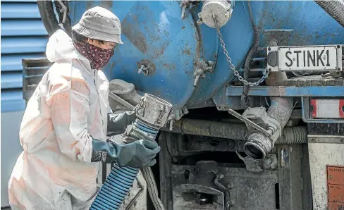  ?? KEVIN/STENT/STUFF ?? A contractor at the Moa Point treatment plant in Wellington connects a waste pipe to a sewage truck for transport of sludge to Southern Landfill.